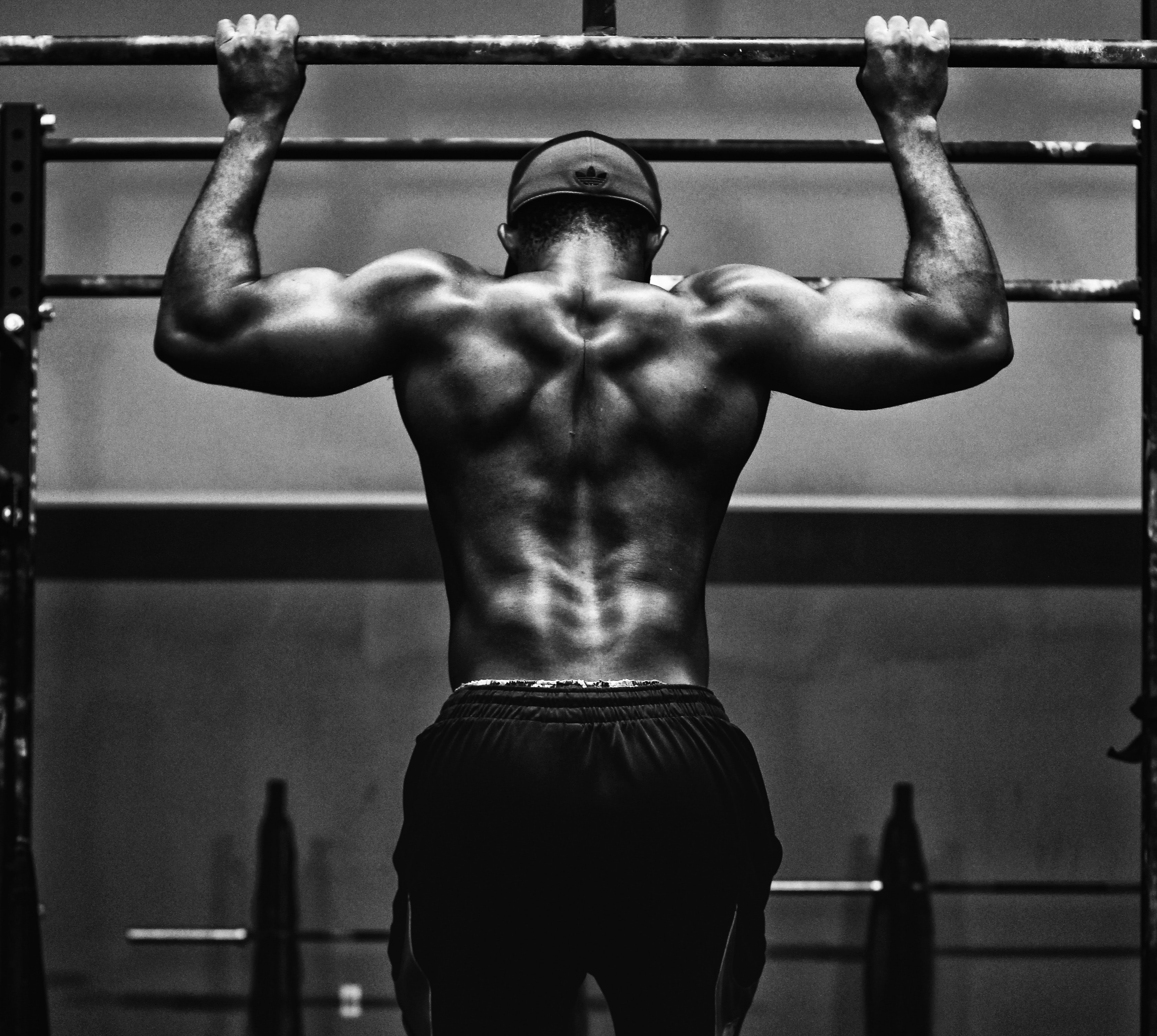 A very fit man doing a pull up